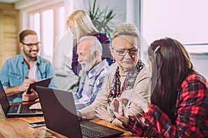 Volunteers help senior people on the computer