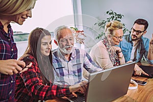 Volunteers help senior people on the computer