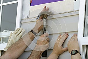 Volunteers Installing Sidiing on a New House