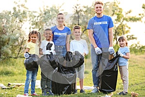 Volunteers with kids collecting trash
