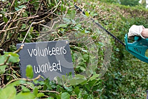 Volunteers needed for garden work. The sentence `volunteers wanted` photo
