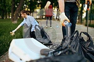 Volunteers picking trash in park, volunteering