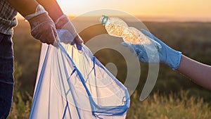 Volunteers put trash in plastic bags. Cleaning the park and caring for the environment