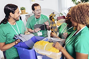 Volunteers putting clothes in donation boxes, social worker making notes charity