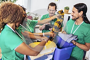 Volunteers putting clothes in donation boxes, social worker making notes charity