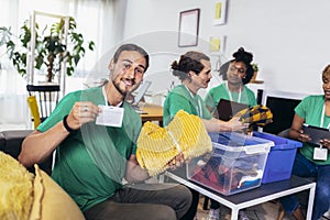 Volunteers putting clothes in donation boxes, social worker making notes charity