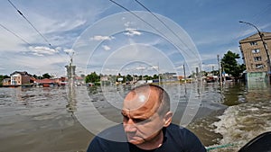 Volunteers sail on boat to evacuate animals and people after detonation of Hydroelectric Power Station. Flooding in