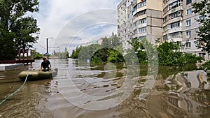 Volunteers sail on boat to evacuate animals and people after detonation of Hydroelectric Power Station. Flooding in