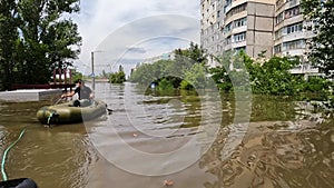 Volunteers sail on boat to evacuate animals and people after detonation of Hydroelectric Power Station. Flooding in