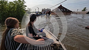 Volunteers sail on boat to evacuate animals and people after detonation of Hydroelectric Power Station. Flooding in