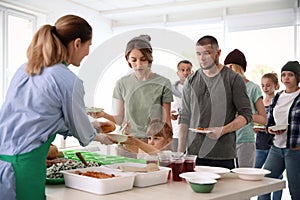 Volunteers serving food for poor people