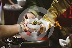 Volunteers serving food for poor people : concept of free food serving photo