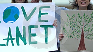 Volunteers showing Love planet slogan, ecological extinction, deforestation