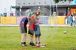 Voronezh, Russia: June 17, 2013. Boys under the water jets in the park on a hot sunny day. Joy, fun