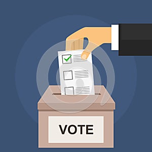 Vote for election concept. Hand puts voting ballot in box photo