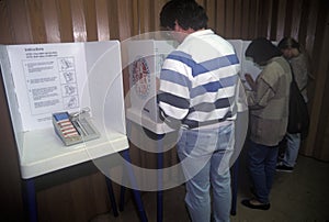 Voters and voting booths in a polling place