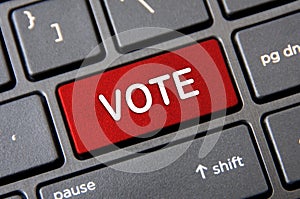 Voting concept - Laptop keyboard with red Vote button.
