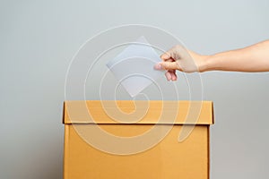 Voting and Democracy concept. Man hand putting ballot in election box, Democracy referendum for government, President and Prime