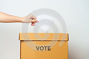 Voting and Democracy concept. Man hand putting ballot in election box, Democracy referendum for government, President and Prime
