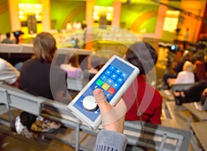 Voting device in boy's hands in auditorium