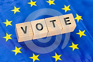 Voting in European Union Countries, Concept, Word Vote written on wooden blocks inside the EU flag