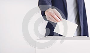 Voting. Man putting a ballot into a voting box