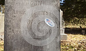 Voting sticker in a graveyard