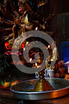 Votive candles and incense, with Buddha