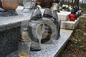 Votive candles lantern on the grave in Slovak cemetery. All Saints' Day. Solemnity of All Saints. All Hallows eve