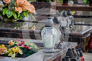 Votive candles lantern on the grave in Slovak cemetery. All Saints' Day. Solemnity of All Saints. All Hallows eve