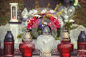 Votive candles lantern on the grave in Slovak cemetery. All Saints' Day. Solemnity of All Saints. All Hallows eve