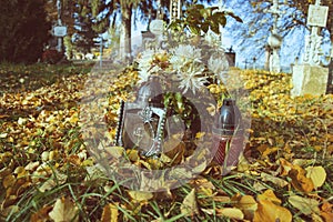 Votive candles lantern on the grave in Slovak cemetery. All Saints' Day. Solemnity of All Saints. All Hallows eve