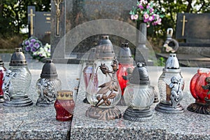 Votive candles lantern on the grave in Slovak cemetery. All Saints' Day. Solemnity of All Saints. All Hallows eve