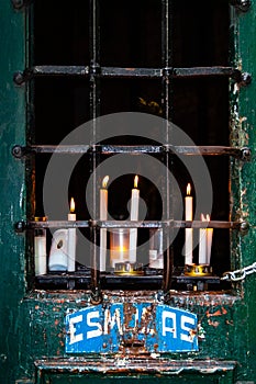 Votive candles on a Station of the Cross aka Calvary and Alms Box