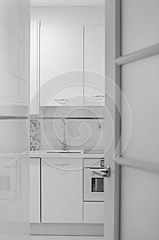 voyeur view of a white kitchen