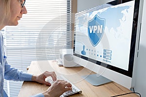 VPN secure connection for telecommuter. Person using Virtual Private Network technology on computer to create encrypted tunnel to photo