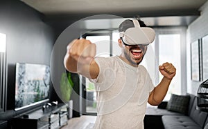 VR, angry and man boxing with glasses, training for a fight and match. Futuristic, digital sports and gamer punching