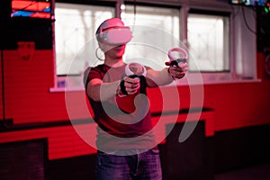 Vr game and virtual reality. man gamer fun playing on futuristic simulation video shooting game in 3d glasses and joysticks gun in