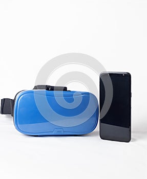 A VR headgear next  to  a cellphone