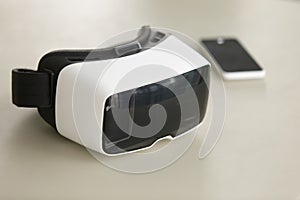 VR headset and smartphone on desk, virtual reality mobile techno