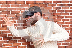 VR headset technology and man at home near brown wall.