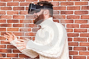 VR headset technology and man at home near brown wall.