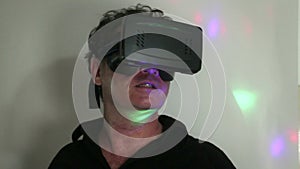 VR: Man in dim room reacts to VR experience with retro lighting effect