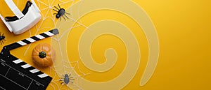 VR movie theatre banner in Halloween theme, pumpkin, spiders, copy space on yellow background