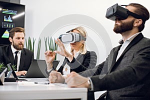 VR, technology and business concept. Team of three professional male and female designers or architects, wearing vr