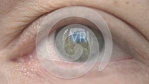 VR or Virtual Reality text on human eye. Technology related macro shot