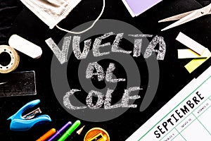 Vuelta al cole text in spanish, meaning back to school, with covid19 face mask on desk with calendar saying septiembre-september photo