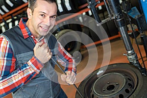 Vulcanizing worker removing tire rim