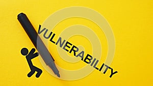 Vulnerability as Weakness Concept with Falling Figure and Marker on Yellow Background