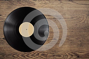 Vynil record disc on wooden table photo